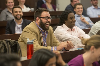 A student laughs while participating in a Kapnick classroom exercise