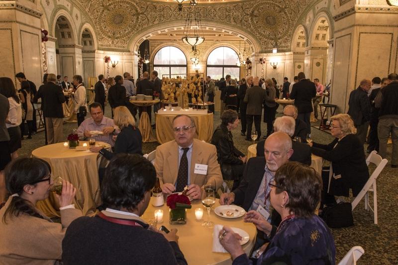 Classmates reconnect at the All-Alumni Wine Mess at the Chicago Cultural Center.