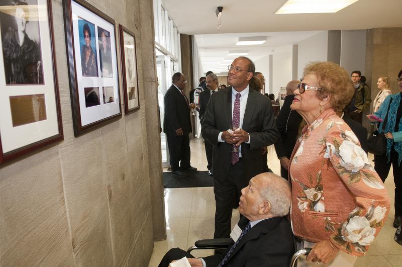 John Rogers Jr., John Rogers Sr., and Gwendolyn Rogers admire the plaque.