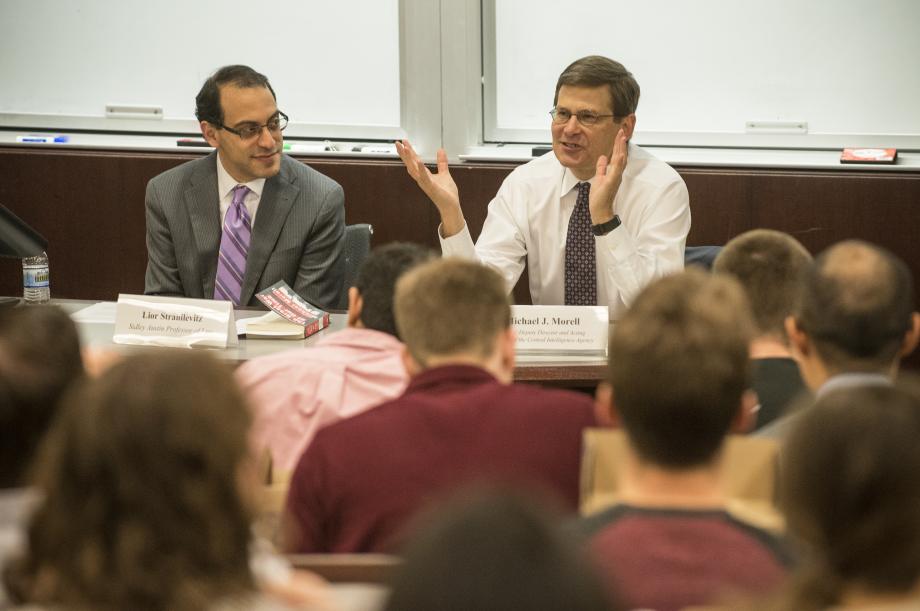 Michael Morell and Lior Strahilevitz sit at table facing a classroom full of students