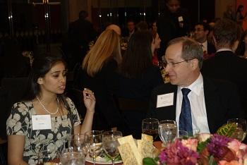 Two people interacting at a formal dinner