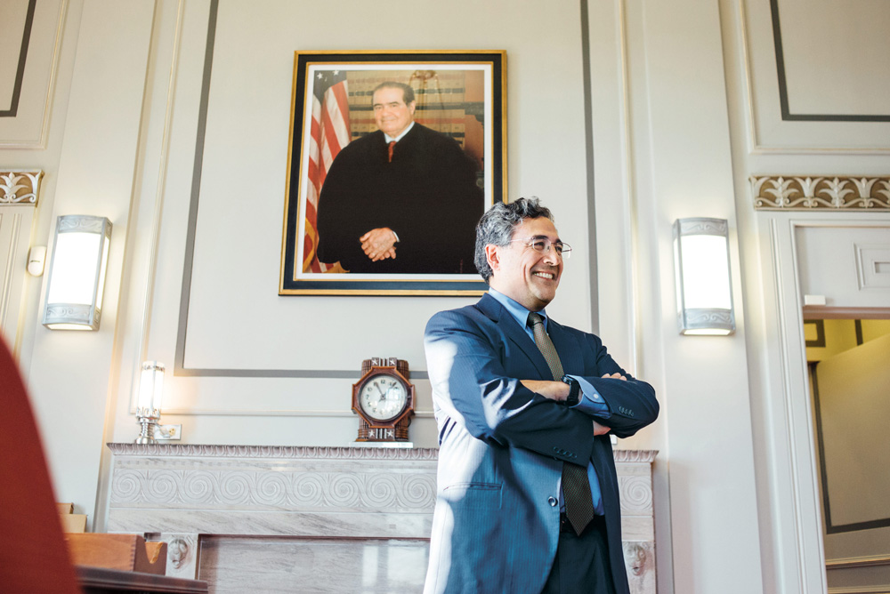 Francisco in his office, beneath a portrait of the late US Supreme Court Justice Antonin Scalia.