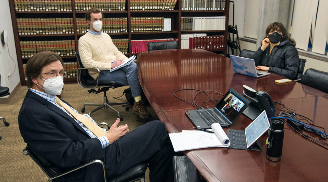 Professor Mark Templeton and Abrams Clinic students sit around a conference table.