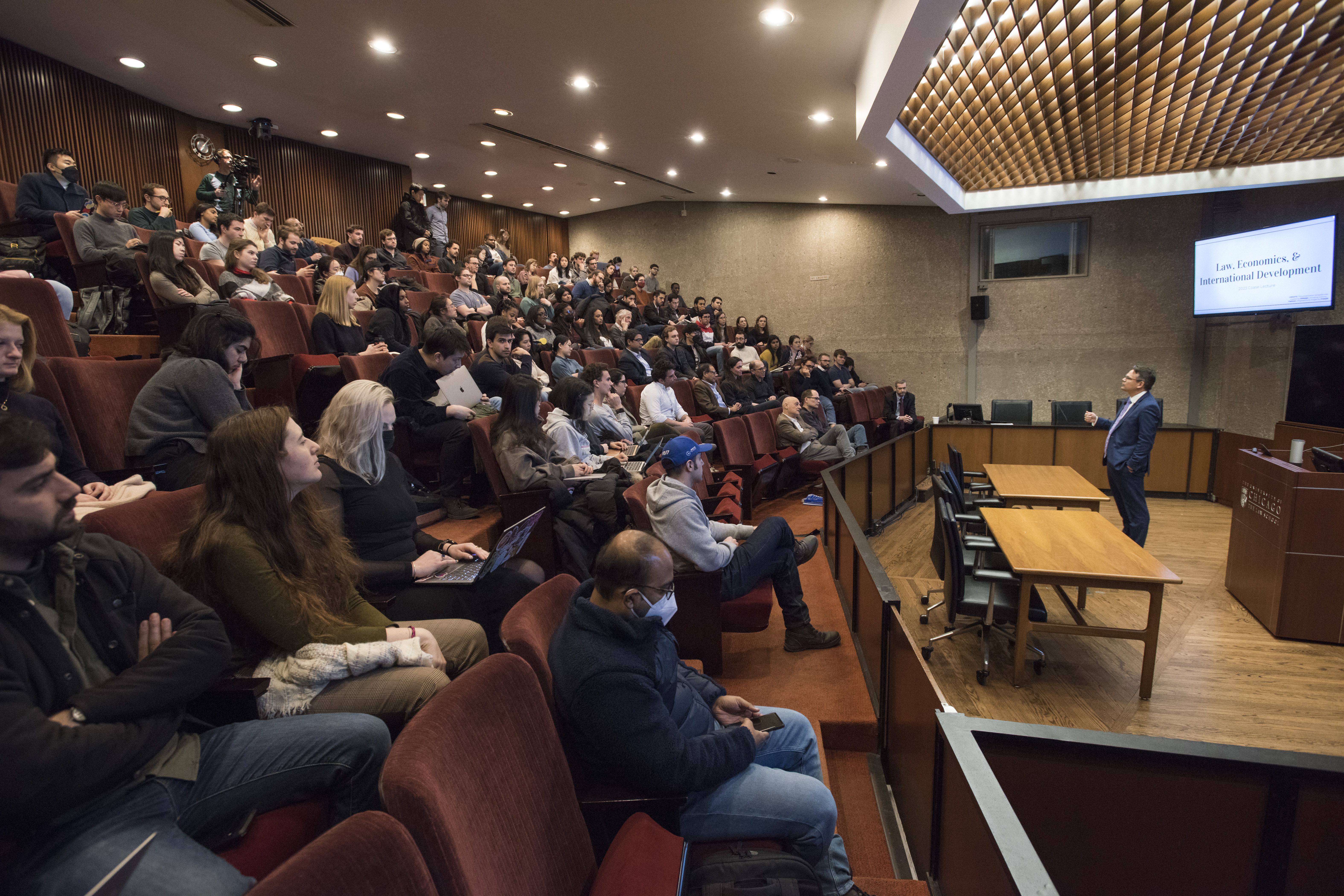 Professor Adam Chilton giving the 2023 Coase Lecture.