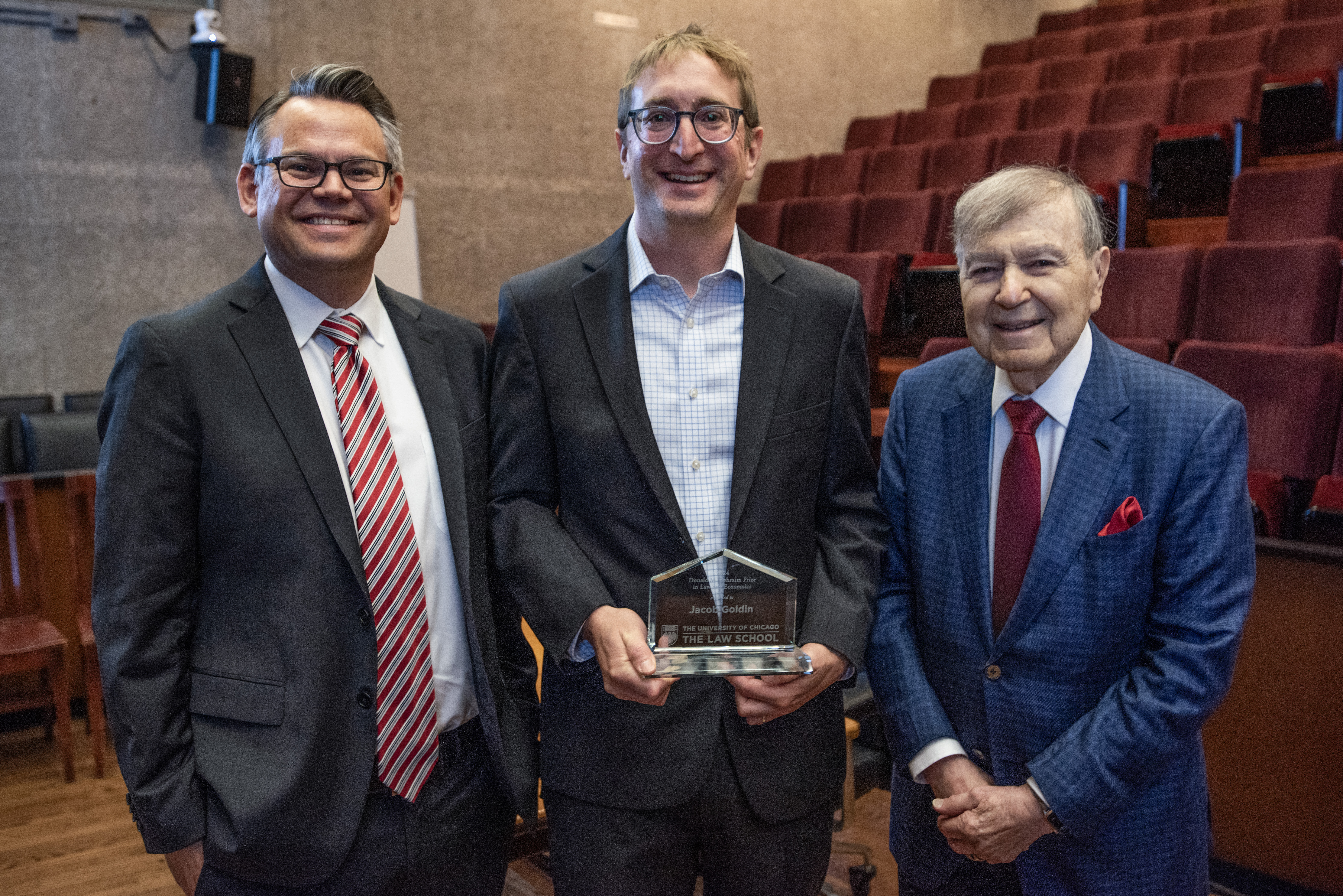 Dean Adam Chilton, Professor Jacob Goldin, and Donald M. Ephraim, all stand side by side to pose for a photo. Professor Goldin is standing in the center and holding his award.
