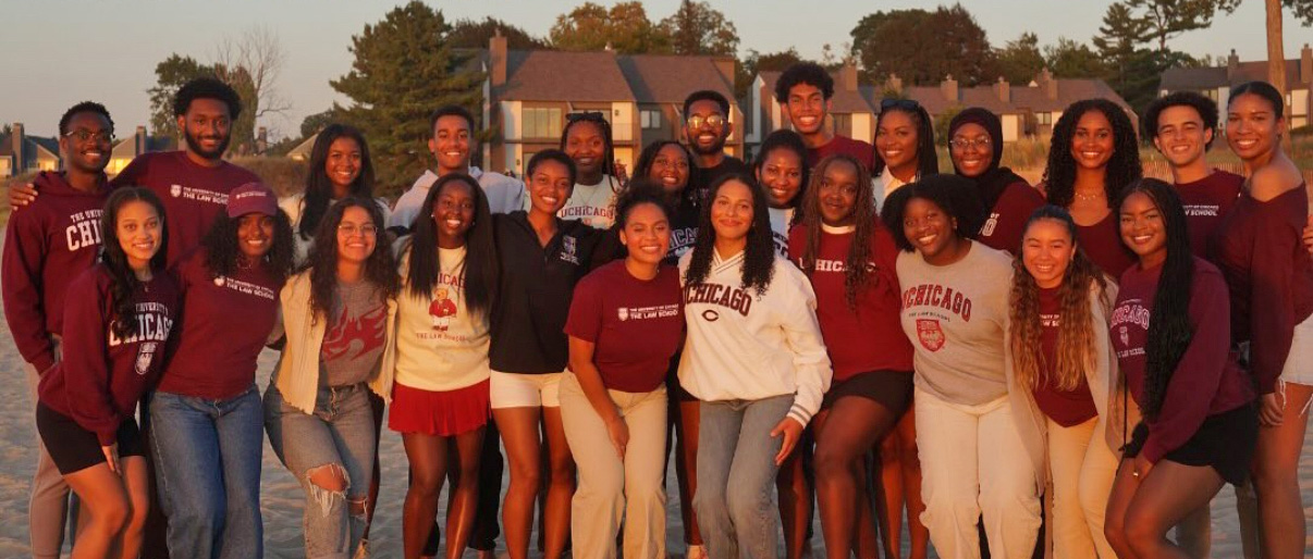 A group of Black law students celebrating on the beach during their retreat.