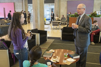 Students and a professor interact in the Green Lounge