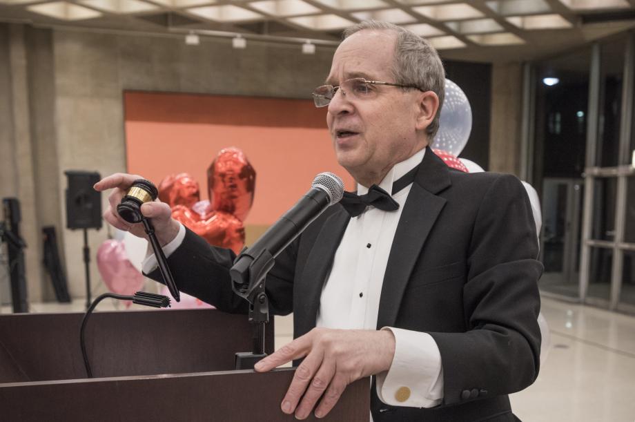 Douglas Baird gestures to a participant in the auction.