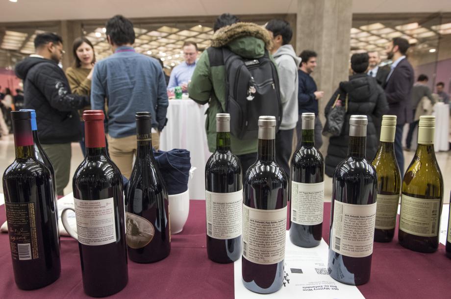 Several bottles of wine sit on a table.