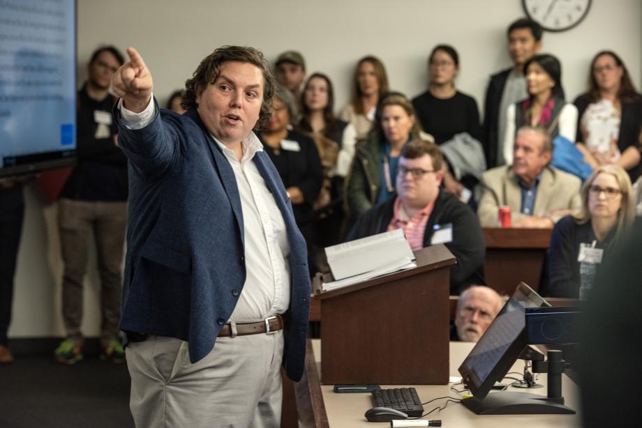 Professor William Baude pointing to something while the mock class looks on.