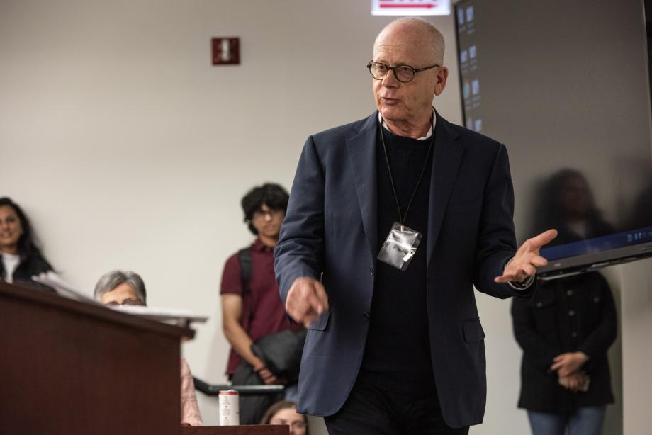 Professor Saul Levmore is speaking, while others watch him in a classroom.