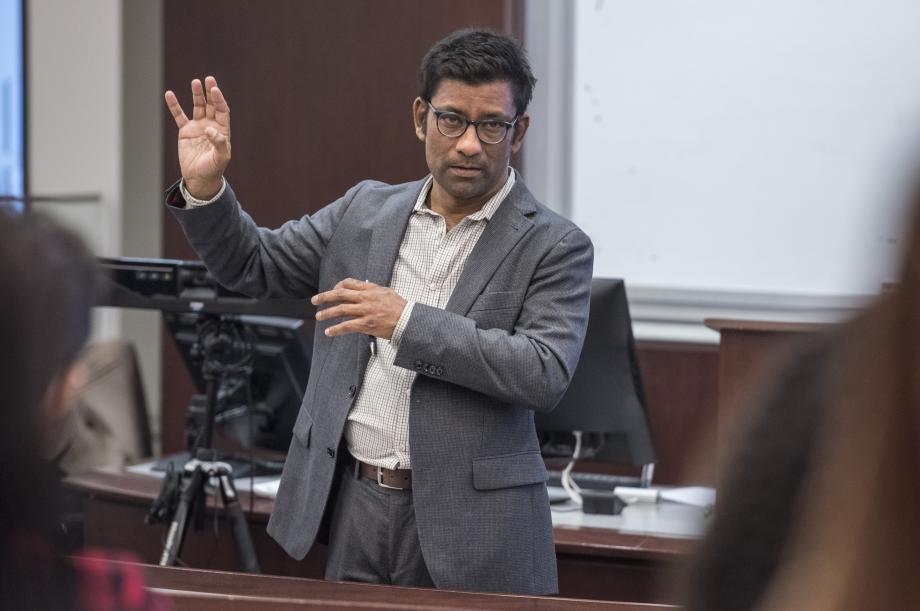 Aziz Huq lecturing in front of a classroom.