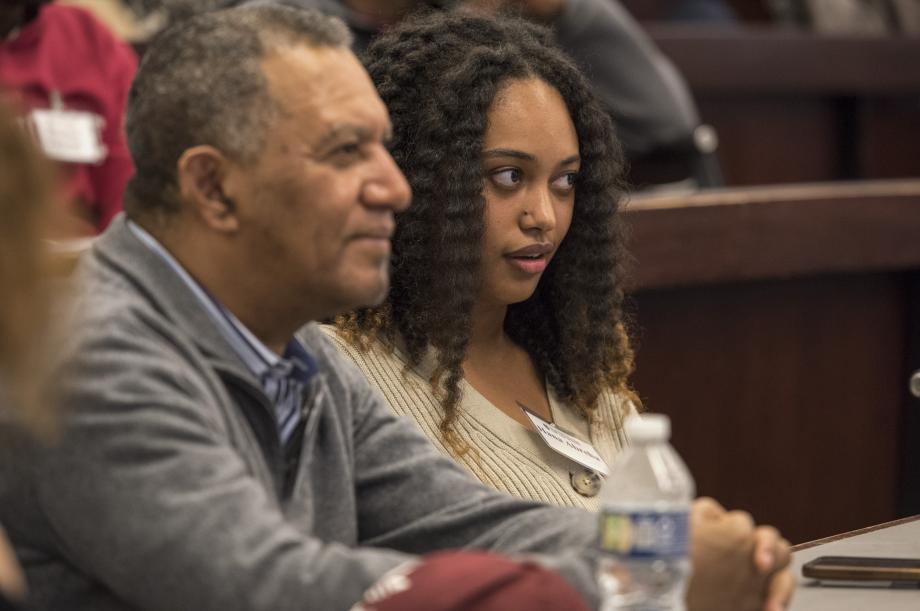 Close up of two people listening in a classroom.