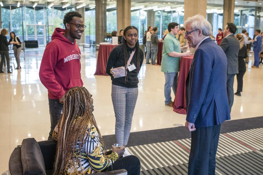 A small group talks to a professor in the Green Lounge.