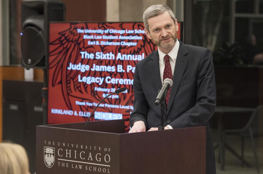 Dean Miles speaks from the podium