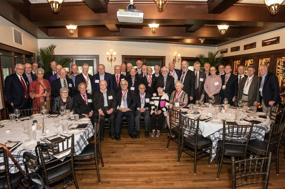 A large group of people pose in a restaurant.