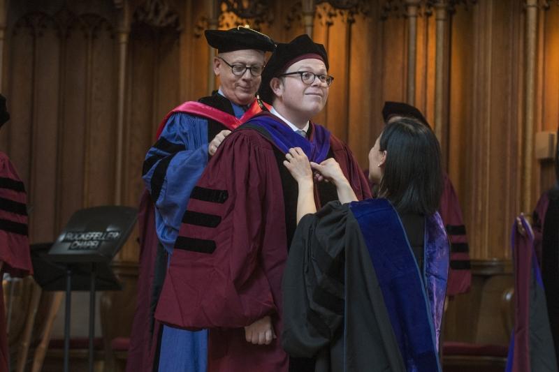 Mateo Aceves is hooded by Professor Levmore and Professor Nou. Mateo Aceves is hooded by Professor Levmore and Professor Nou.
