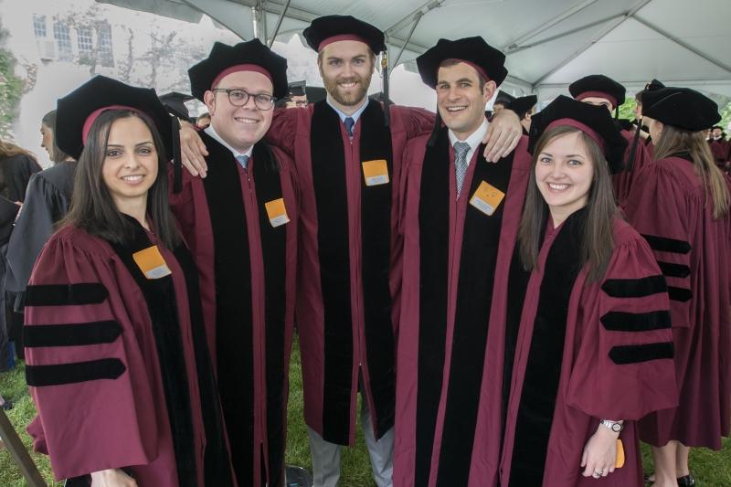 The graduates pose for a photo in their maroon robes, right before the Diploma & Hooding Ceremony. The graduates pose for a photo in their maroon robes, right before the Diploma & Hooding Ceremony.