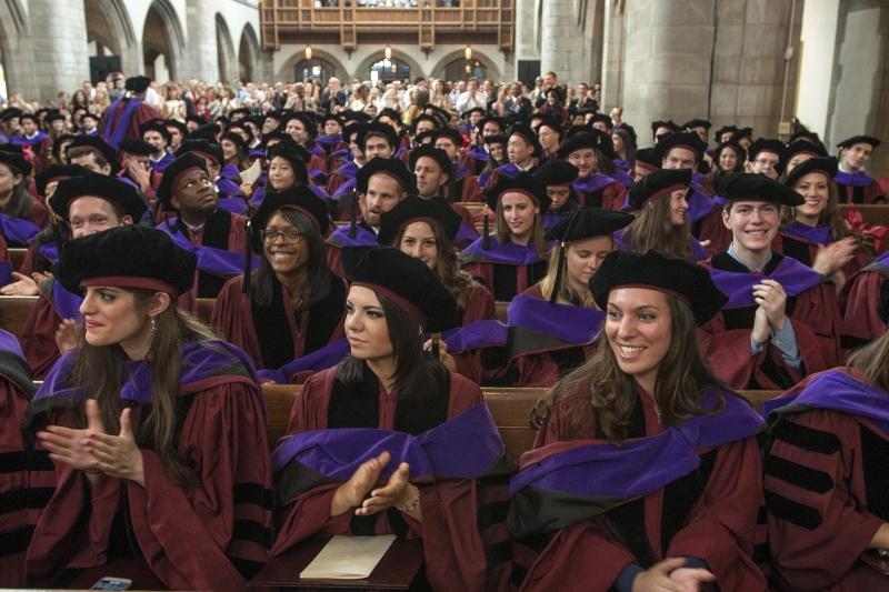 Graduates of the Law School applaud in their hoods after the ceremony. Graduates of the Law School applaud in their hoods after the ceremony.