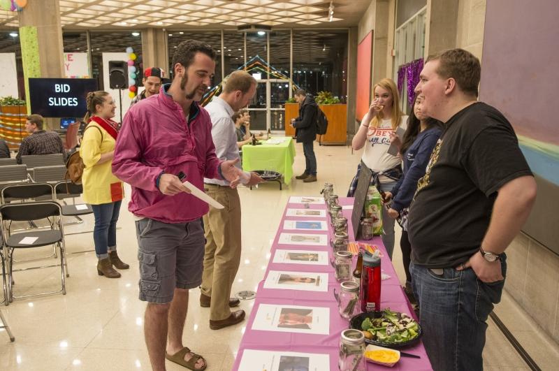 Joe Egozi, '17, talks to Matt Enloe, '18 by the voting table for the annual Oliv