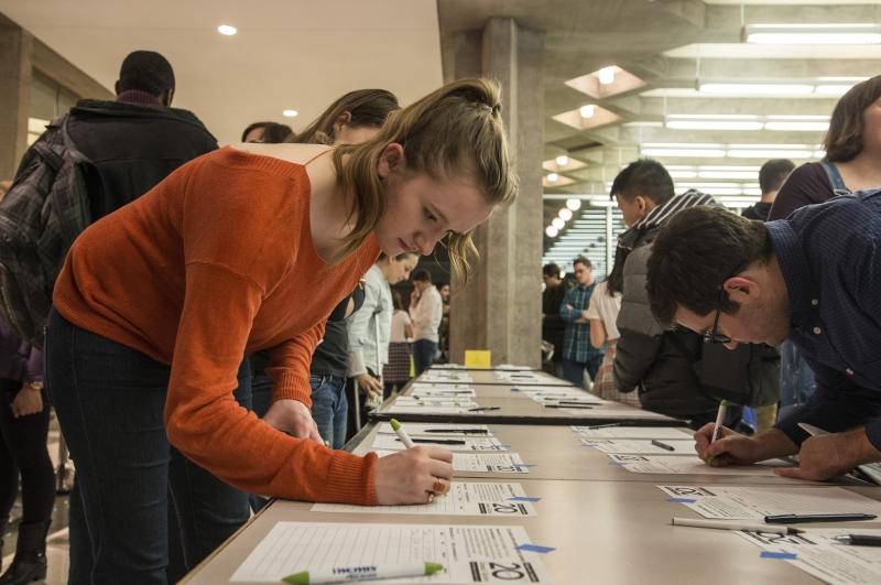 Bidding becomes a sport at the auction, and students closely watch over the bid 