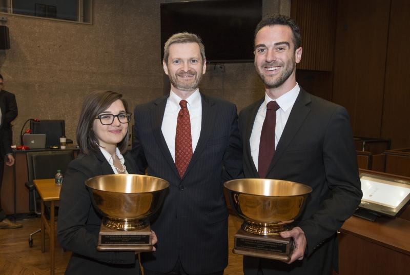 Kaitlin Beck, '17, and Joe Egozi, '17, shown with Dean Thomas J. Miles, took first place in the final round.