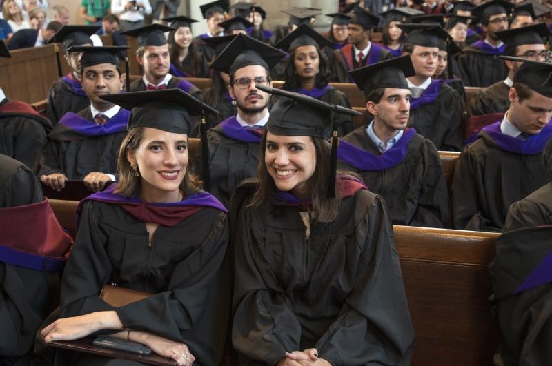 LLM graduates posed for a photo after receiving their hoods.