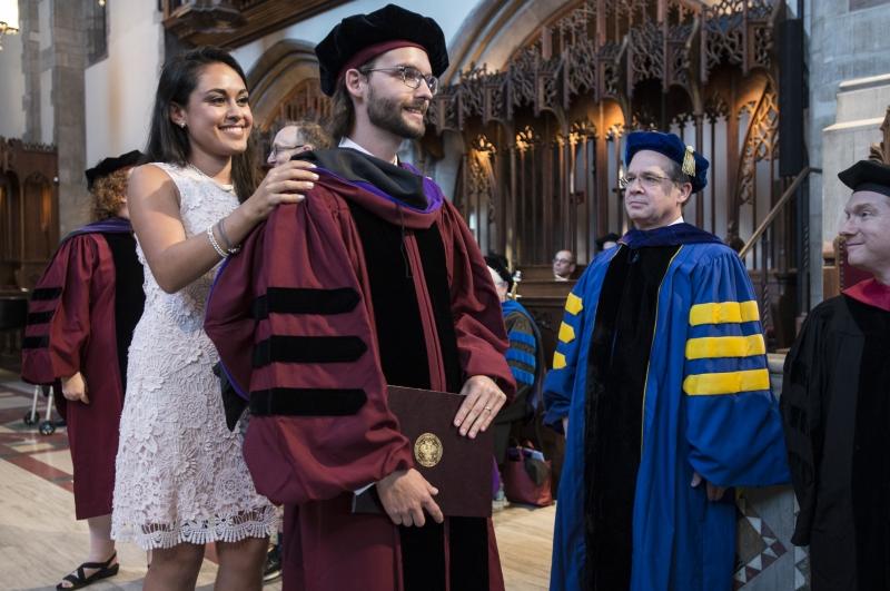 Kristoffer Gredsted, '17, received his hood from his wife, Monica Norzagary Pedraza, LLM '14. Kristoffer Gredsted, '17, received his hood from his wife, Monica Norzagary Pedraza, LLM '14.