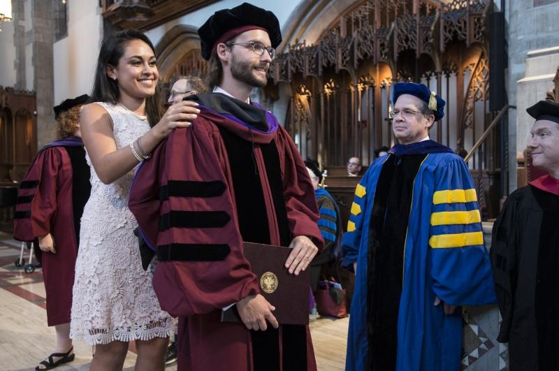 Kristoffer Gredsted, '17, received his hood from his wife, Monica Norzagary Pedraza, LLM '14.