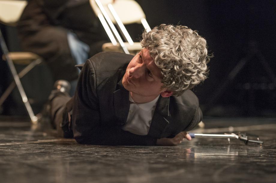 Joseph Thomas, '18, as Professor Geoffrey R. Stone, lies on the ground after getting hit by a 172 bus during the tornado.