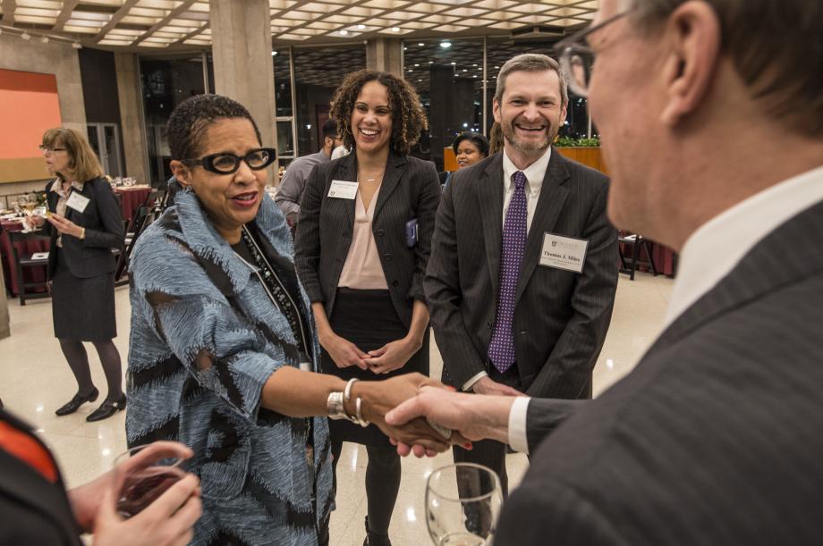 The evening's honoree, Judge Ann C. Williams, now retired from the Seventh Circuit Court of Appeals, greets guests while Dean of Students Shannon Bartlett and Dean Thomas Miles look on. 