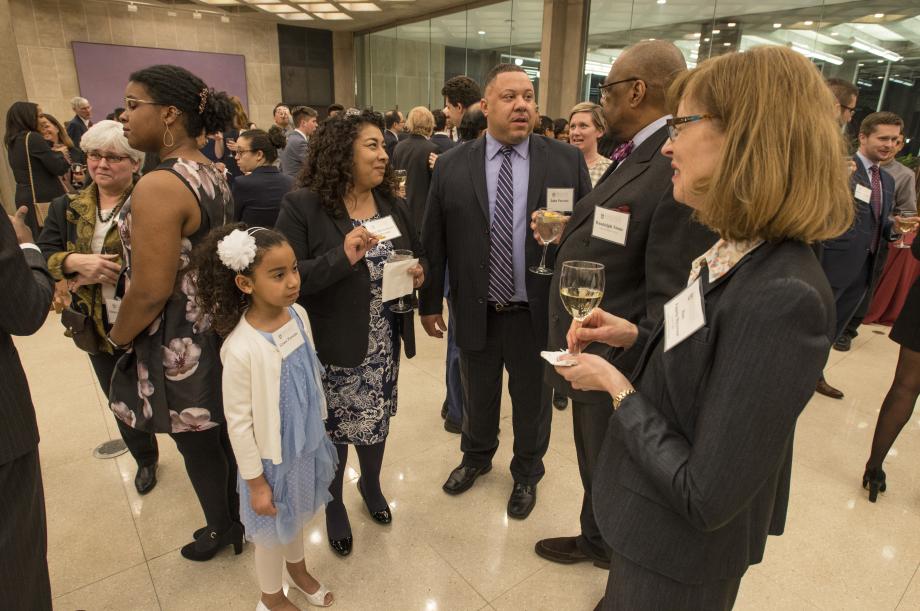 Judge Parsons' grandson, John Parsons (center), his wife Mary Helen Reyna de Parsons (left), and their daughter, Grace, get to know Professor Randolph Stone and Pam Meyerson, '83, before dinner. 