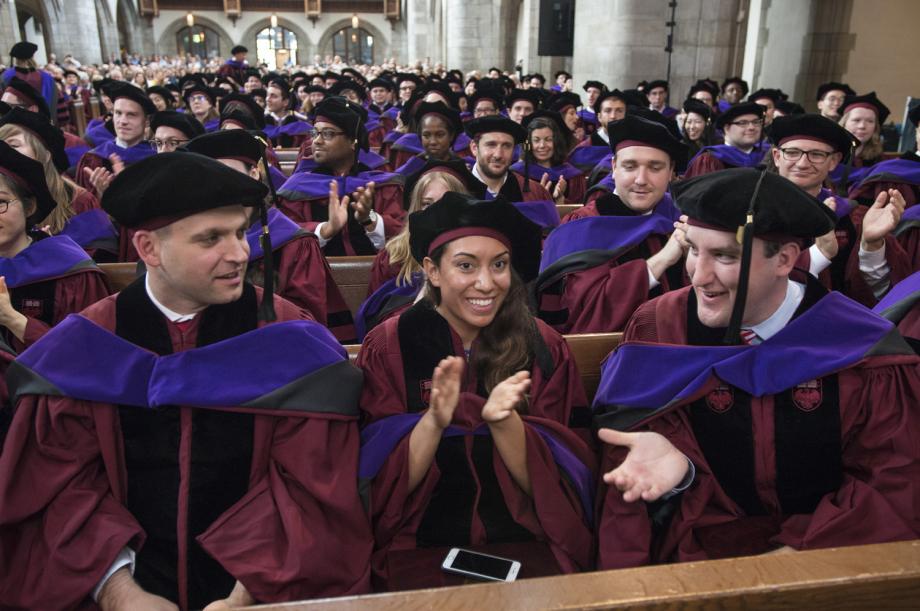 The JD Class of 2018 applauded in their hoods after receiving their diplomas.