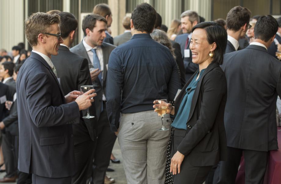 Professor Jennifer Nou (right) laughs with students. 