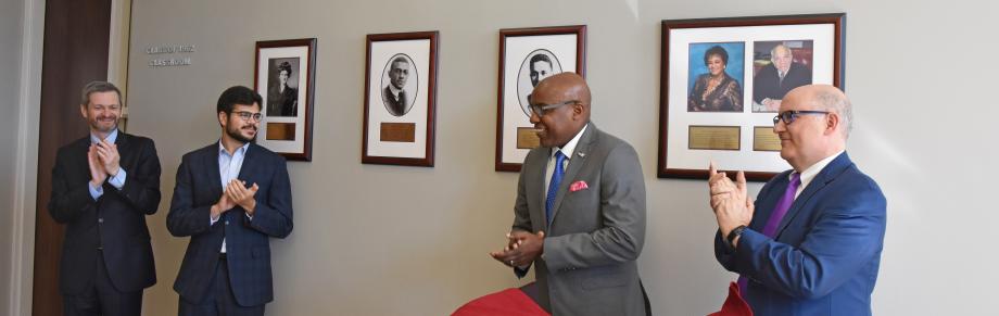 Dean Thomas J. Miles; Adam Hassanein, ’21; Illinois Attorney General Kwame Raoul; and Deputy Dean Richard McAdams at the unveiling of the Nelson Willis photograph. 