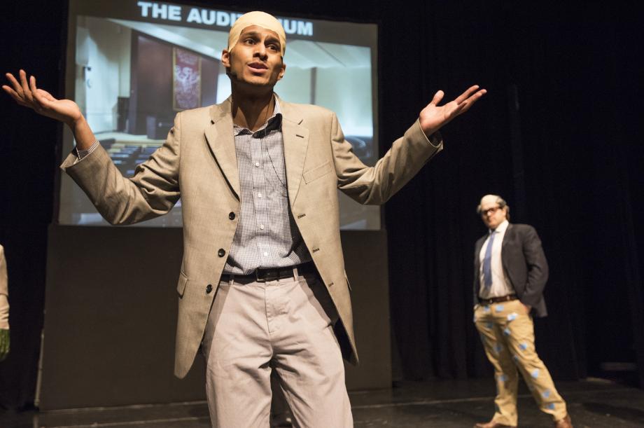 Levmos (played by Rahul Srinivas, '19) sing to the students about meeting in the middle.