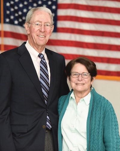 Douglas Kraus and Alice Weigle Kraus in front of an American flag