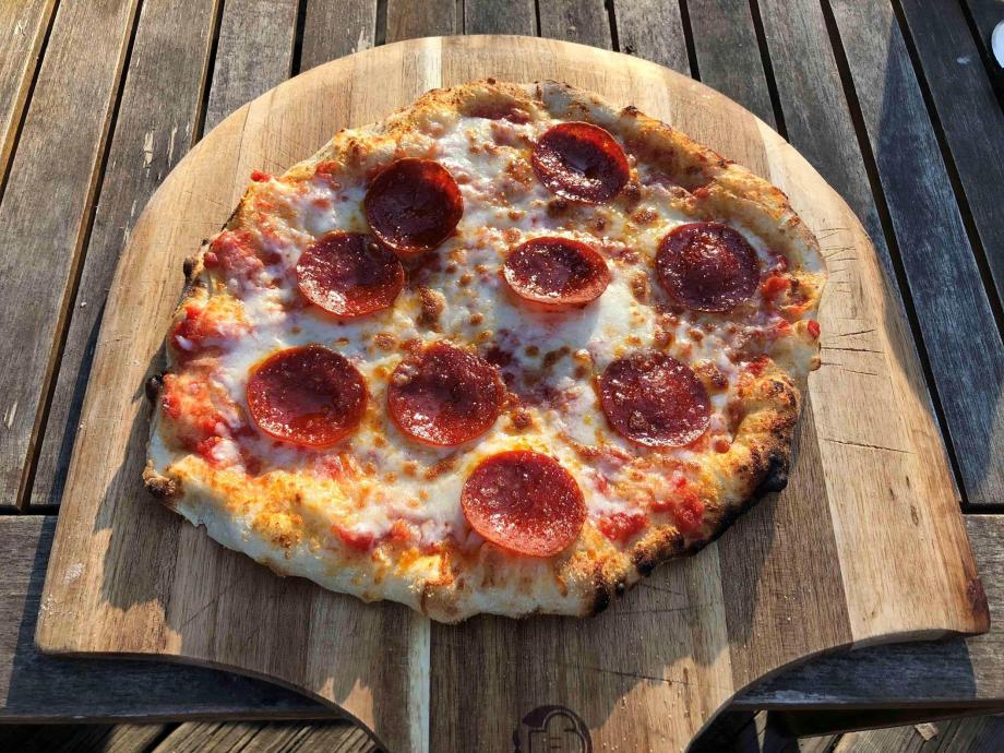 Pizza on a wooden peel