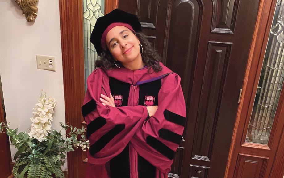 Student Leena El-Sadek at home in her regalia