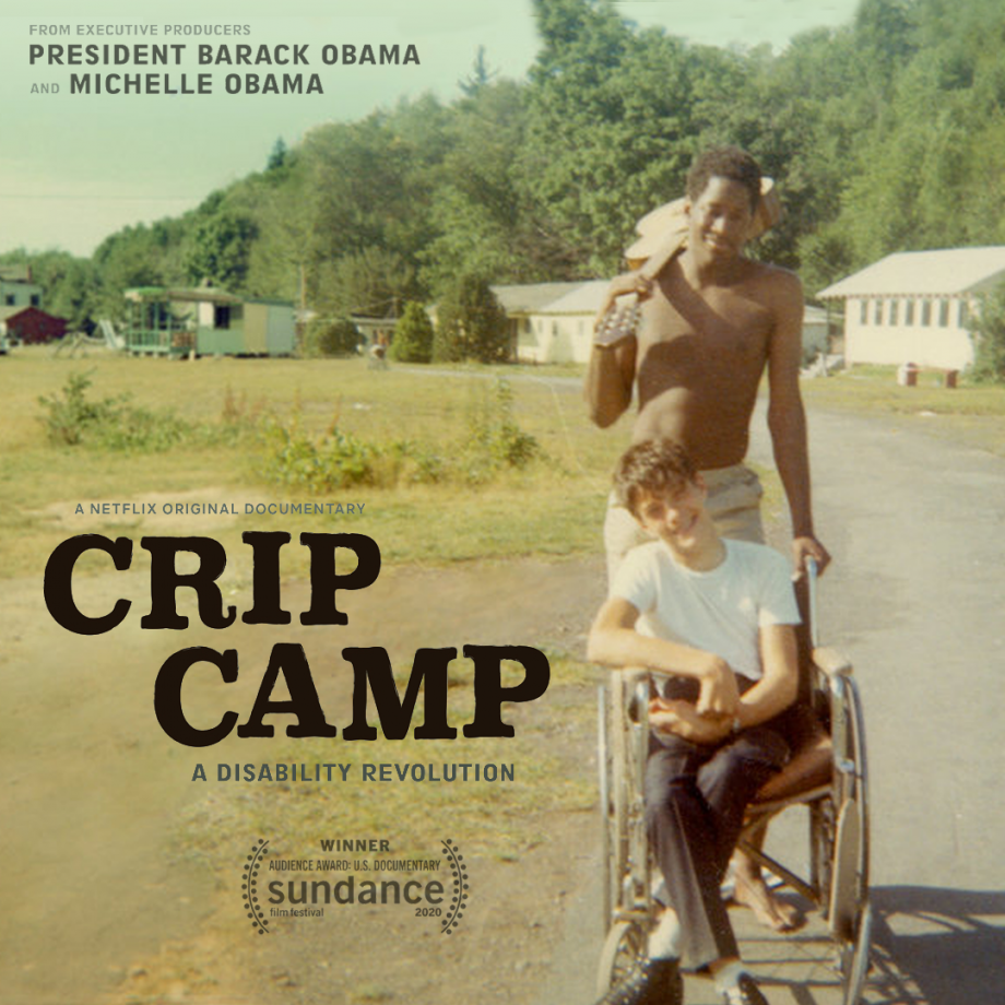 The poster for the Netflix documentary Crip Camp. The poster depicts two smiling young men. One is in a wheelchair and the other is standing behind the wheelchair with a guitar slung over his shoulder. 