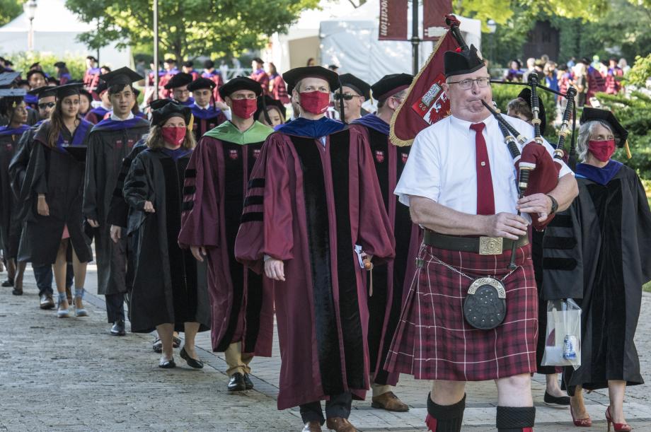 After an unexpected weather delay—a thunderstorm that required everyone to temporarily seek shelter—graduates were escorted to their seats by a traditional bagpipe procession.
