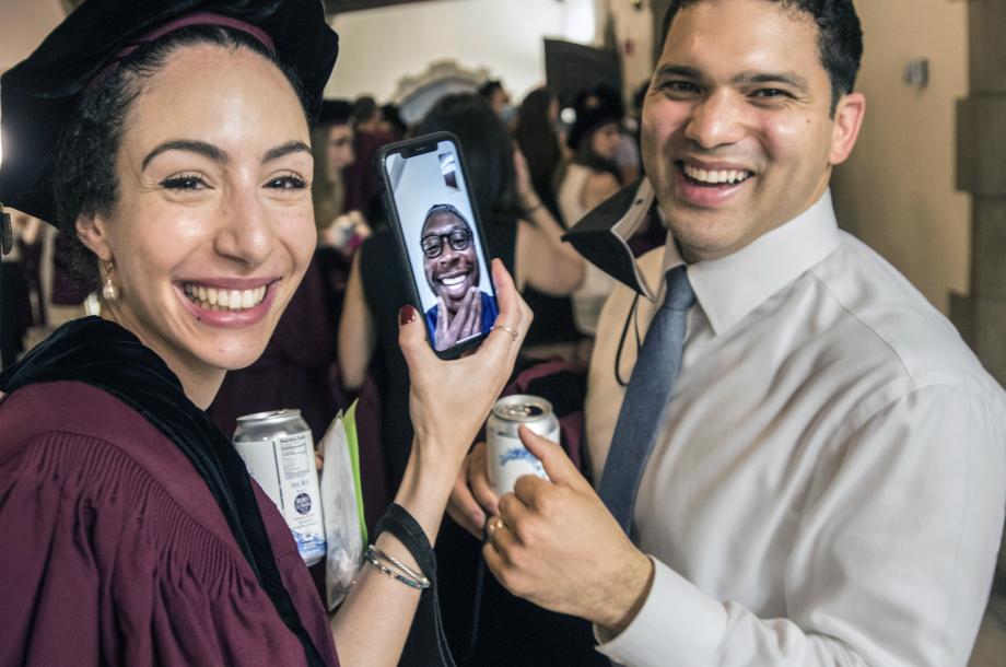 Two students talk to a friend on the phone.