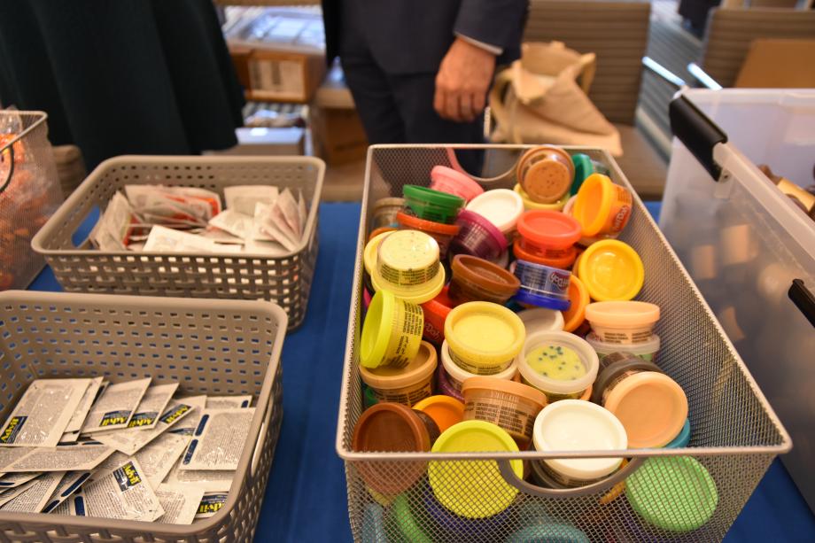 A close up of plastic bins will with stress kit items.