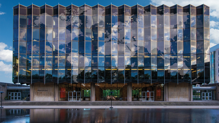 Map of the world superimposed as clouds reflecting off of the Law School building