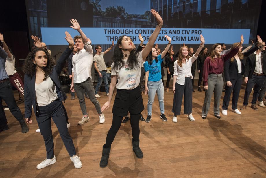 Students gather on stage to sing, the "Bell Curve of Life."