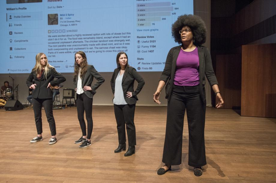 Four students portraying clinical professors sing on stage.