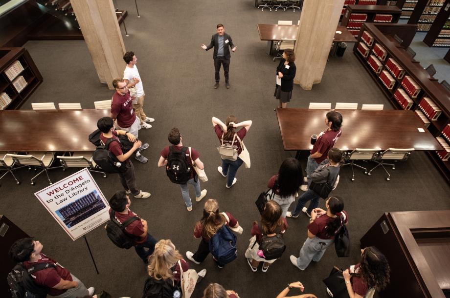 Students gather in the library, as shown from above.