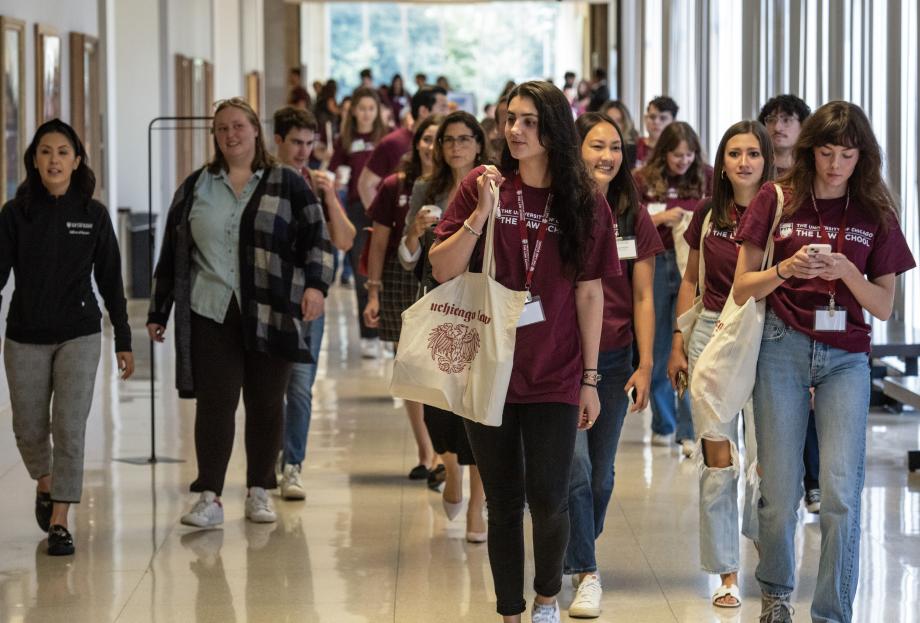 Dozens of students mill in the classroom hallway.