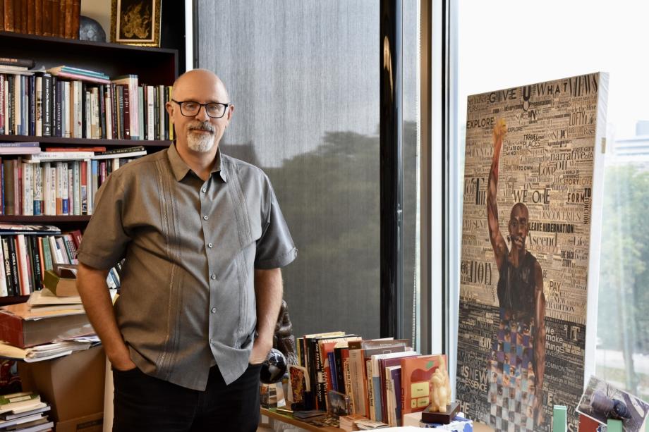 Tom Ginsburg stands in front of a bookcase in his office.