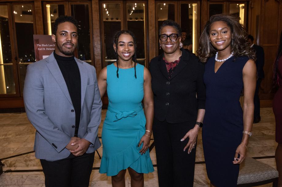 Sharon Johnson Coleman and three students smile at the camera.